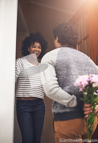 Image of Surprise, flowers and woman with man by door for anniversary or romantic gift at apartment. Happy, shock and back of male person with bouquet of pink floral plants for girlfriend at modern home.