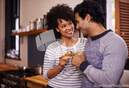 Image of Couple, wine and cheers for love, romance and passion for romantic, dating and relationship together. Boyfriend, girlfriend and young people for interracial pair for happy and drink in kitchen