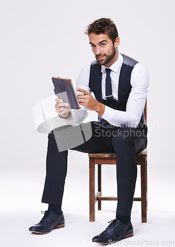 Image of Studio, portrait and man with chair, tablet and business for style and fashion. Professional, lawyer or attorney with corporate, technology and consultant with suit isolated on white background