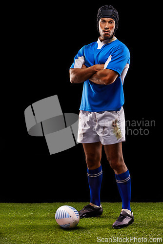 Image of Rugby, portrait and man in studio with arms crossed for training, competition and sportswear in black background. Night, ball and young male athlete for confidence for professional sport or workout