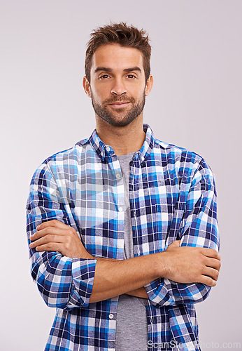 Image of Portrait, arms crossed and man in studio for fashion isolated on a gray background. Cool person, face and confidence in casual clothes for trendy style in shirt outfit on a backdrop in Australia