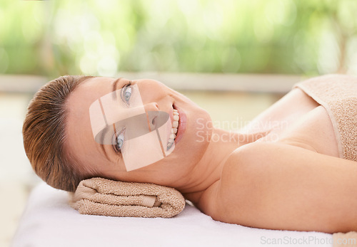 Image of Woman, face and smile at spa, massage and wellness with calm for zen and self care. Cosmetics, beauty and facial, relax and peace at luxury resort with treatment for stress relief and portrait