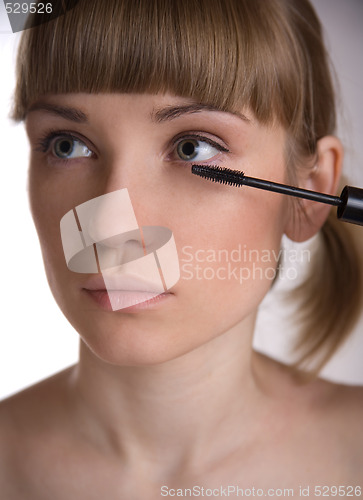 Image of Applying make-up. 