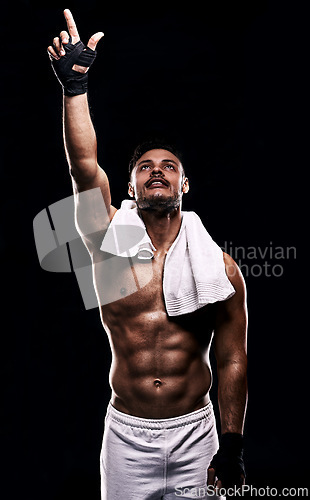 Image of Man, boxer and hand in studio for faith, fitness and pointing up for training on black background. Person, athlete and strong muscles for workout or exercise, religion and battle or competition