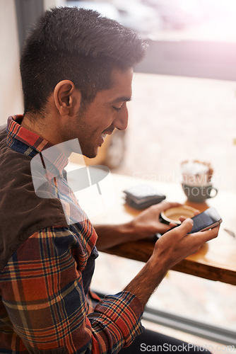 Image of Happy man, coffee and typing with phone for social media, communication or networking at indoor cafe. Male person on mobile smartphone with smile for online chatting, texting or app at restaurant