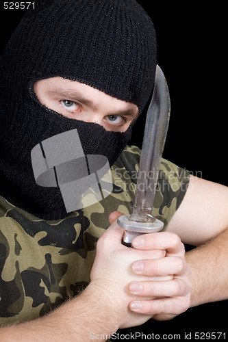 Image of The murderer with a knife in a black mask