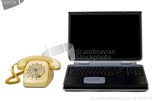 Image of Laptop and old phone. Isolated on white