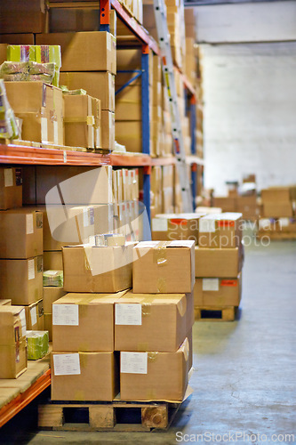 Image of Boxes, packages and shelves with inventory at warehouse for distribution, supply chain or logistics. Empty room or interior of parcel, cargo or shipment in factory or storage for export or import