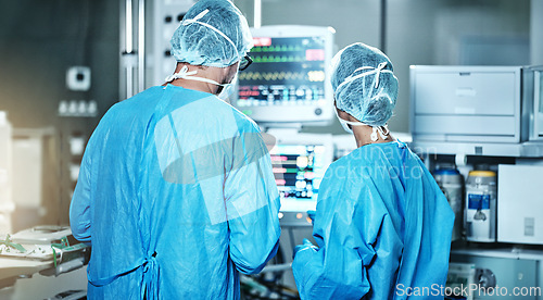 Image of Surgery, back or surgeons with teamwork for emergency, accident or healthcare in hospital clinic. Heart rate monitor, medical or doctors in surgical collaboration in operating room to support or help