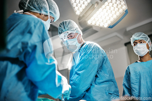 Image of Theatre, icu or surgeons with teamwork for emergency, accident or healthcare in hospital clinic. Surgery operation, medical or doctors in surgical collaboration in operating room to support or help