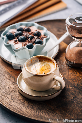 Image of Coffee break in a office, cup of coffee with healthy yogurt in a office. 