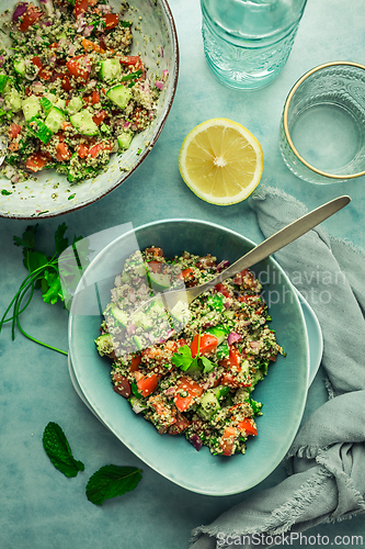 Image of Tabbouleh salad. Fresh homemade Tabouli salad with fresh parsley, onions, tomatoes and hempseeds