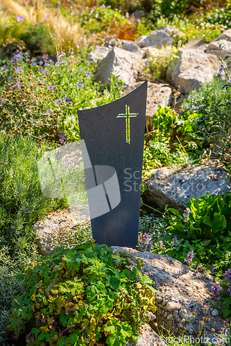 Image of Modern gave cross and tombstone decorated with native plants and succulents