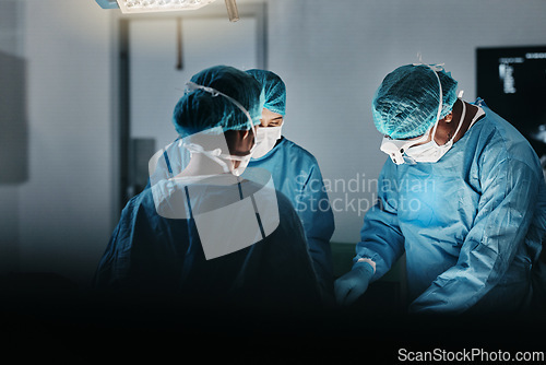 Image of Surgeon team, people and operating room at hospital in scrubs, ppe and help for emergency healthcare procedure. Doctors, group and together in icu, medical surgery and services for wellness at clinic