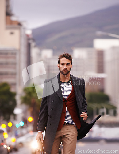 Image of Man, walking in city and fashion, confidence and serious outdoor with winter coat for style and aesthetic. Urban, chic and edgy with pride, portrait and model in stylish clothing, apparel and outfit