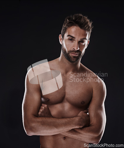 Image of Portrait, muscle and body of confident man in studio isolated on a black background for wellness, sexy or six pack. Model, face and topless person with arms crossed for health and strong abs in Spain