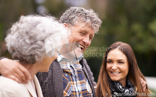 Image of Senior parents, hug and outdoor with daughter, adult and happy with humor and bonding together. Nature, old mother or elderly father with embrace or vacation with smile or cheerful with weekend break