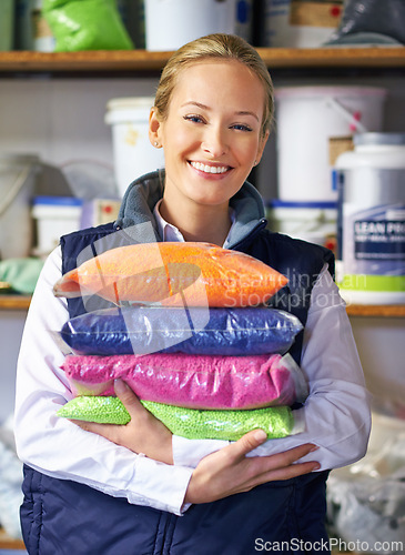 Image of Woman, polymer and plastic in factory, pellets and dye manufacturing and ecology in portrait at store. Person, color and employee for recycling at plant with storage, particles and bags in warehouse