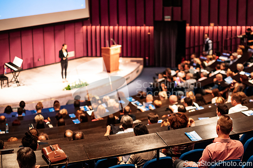Image of Woman giving presentation on business conference event.