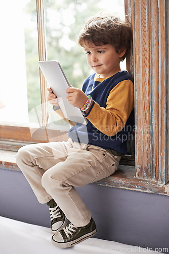 Image of Home, tablet and young kid on app, internet and game on website for learning by windowsill. Technology, child and boy in house for education, relax and watch cartoon online on digital electronics