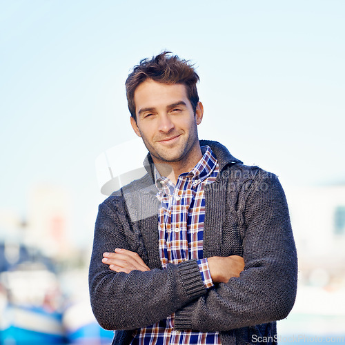 Image of Smile, crossed arms and portrait of man at harbor on travel for vacation, adventure or holiday. Happy, outdoor and confident person by sea port on weekend trip in Cape Town with positive attitude.