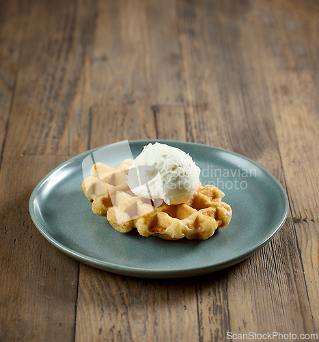 Image of plate of belgian waffle with vanilla ice cream