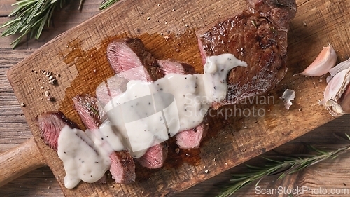 Image of freshly grilled sliced beef steak with pepper sauce 