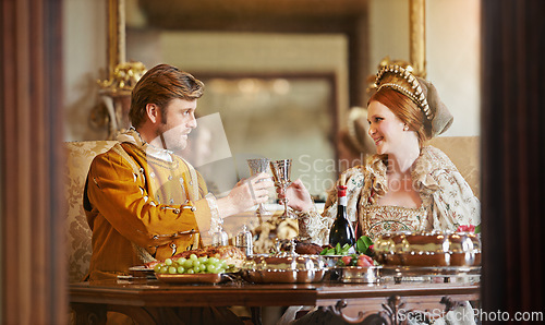 Image of Royal, man and woman with luxury for dinner, wine and toast together for wedding and coronation. King and queen with smile for food with alcohol to drink in palace, happiness and joy for marriage