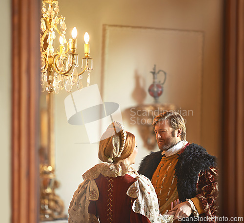 Image of Victorian, man and woman talking in royal castle together with vintage love, romance and banquet hall. Medieval king, queen or renaissance couple in ballroom holding hands with conversation in palace