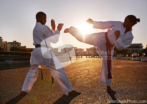 Image of People, karate and martial arts with personal trainer for self defense, technique or style in city street. Man and woman fighter or athlete in fitness training, fighting or kick boxing in urban town