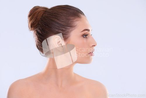 Image of Beauty, skincare and profile of woman with wellness, shine and benefits of facial cosmetics in studio. Dermatology, health and face of girl with natural makeup, glow and skin care on white background