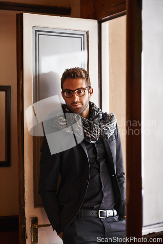 Image of Man, portrait and fashion in house for style and clothes for bold and trendy indoor. Young person, smile and handsome with scarf and jacket for winter wear and comfort for edgy and aesthetic
