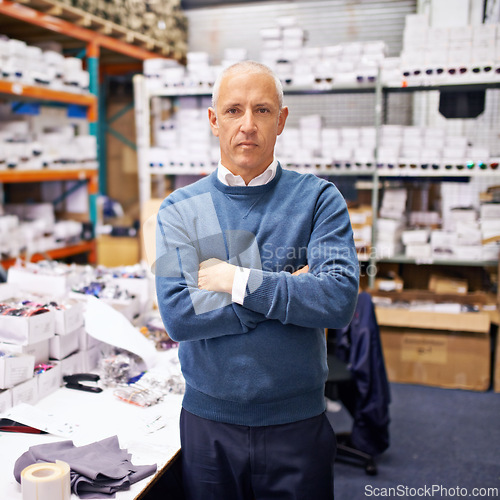 Image of Portrait, man and confident by shelves in distribution warehouse and pride in career as inspection of stock. Mature face, professional or arms crossed in job or administration of inventory on site