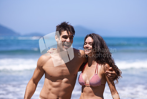 Image of Beach, travel and couple with vacation, sunshine and weekend break with journey and summer. Ocean, seaside and embrace with man and woman with holiday and love with anniversary, happy and adventure