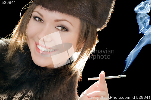 Image of Portrait of the smiling young woman with a cigarette