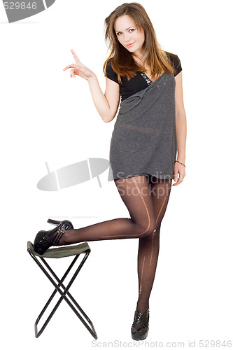Image of Young woman in the torn stockings and a chair. Isolated