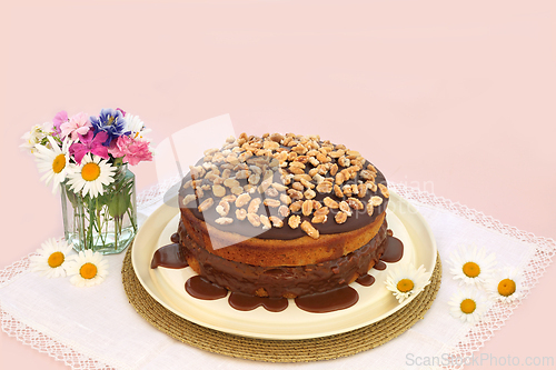 Image of Peanut and Caramel Homemade Cake with Summer Flowers