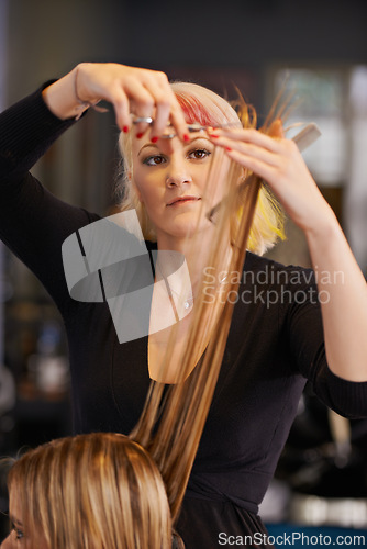 Image of Woman, hairdresser and customer with scissors at hair salon for grooming, styling tools and haircare. Women, comb and appointment for beauty industry with hairstyle, makeover and color treatment