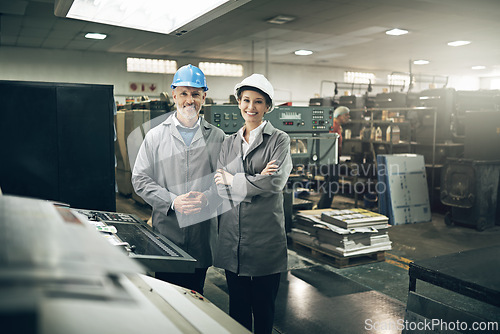 Image of Man, woman and printing press for industry with smile in factory in portrait with team, packaging and manager. People, workers and together in warehouse for manufacturing with industrial production