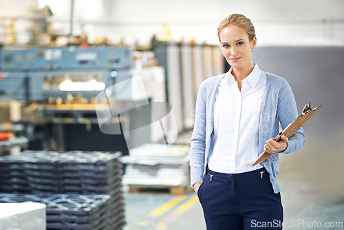 Image of Business, clipboard and woman in suit in warehouse with production, paperwork and administration. Portrait, female person and confident with stock or information capture in logistics company