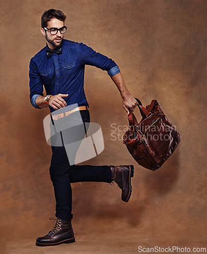 Image of Travel, bag and man with fashion walking in studio, background and mockup for business vacation. Formal, style and model with luxury luggage for airport, journey to Italy and Italian leather shoes