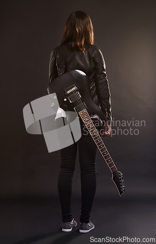 Image of Woman, guitar and fashion for musical instrument, sound and trendy for retro and style on dark background. Young person or musician for creative, funky and edgy for bold with leather jacket for rock