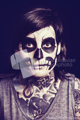 Image of Skull, cosmetics and portrait of woman on dark background for festival, Halloween and day of the dead. Makeup, costume and person with face paint for horror, scary and gothic aesthetic in studio