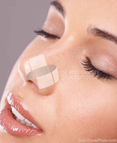 Image of Closeup, woman and makeup for skincare, beauty and cosmetology in facial, health and wellness. Female person, cosmetics and flawless skin for dermatology as self care in studio on grey background