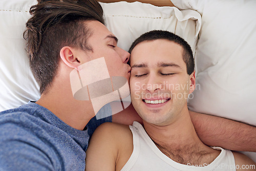 Image of Men, gay couple and bedroom kiss for relaxing embrace for waking up together, lgbt or partnership. Male people, love and weekend peace in home apartment for queer relationship, hugging or homosexual