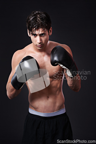 Image of Fitness, boxing and gloves on man in studio for exercise, challenge or competition training for gym. Power, muscle or serious champion boxer at workout with confidence, fight and black background