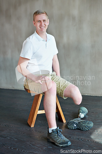 Image of Man, happy and amputee with prosthetic leg in gym sitting, residual limb for balance. Workout, physiotherapy and fitness for wellness or male person with disability, exercise and rehabilitation