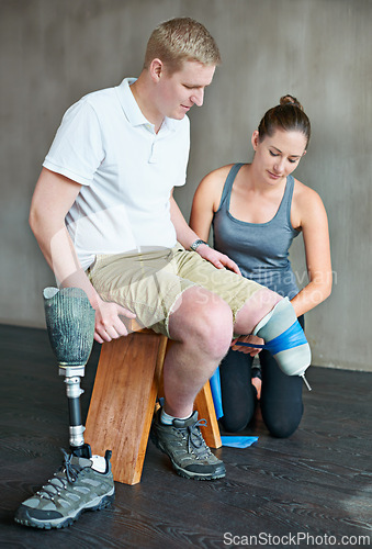 Image of Physiotherapist, rehabilitation and prosthetic leg in clinic for support, physiotherapy, and stretching. Physical therapist, help and training person with disability for wellness, therapy and health