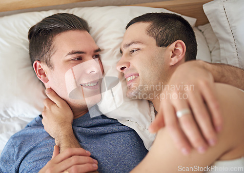 Image of Happy, men and top view of gay couple in bed at home to relax, embrace and bonding together in the morning. Lgbtq, above and smile of people in bedroom for love, connection and healthy relationship