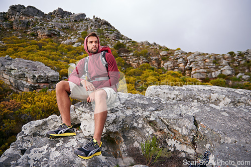 Image of Man, mountains and view with thinking, travel and hiking for fitness and fresh air with backpacking outdoor. Calm, peace and wellness in nature, trekking and adventure for exploring with mindfulness